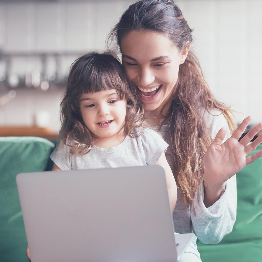 Child participating in an online tutoring session with her mother